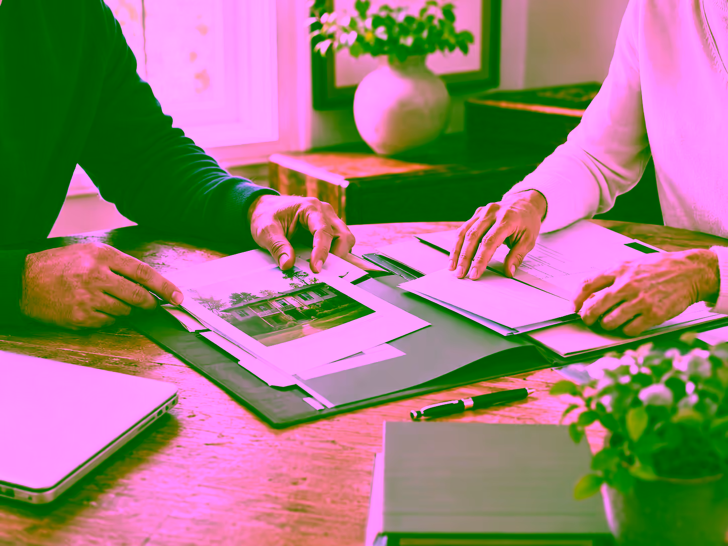 Two people reviewing a marital agreement and financial documents at a table